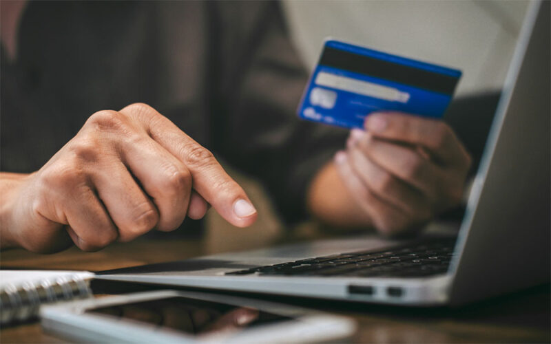 man using credit card - How Much Does Ahrefs Cost