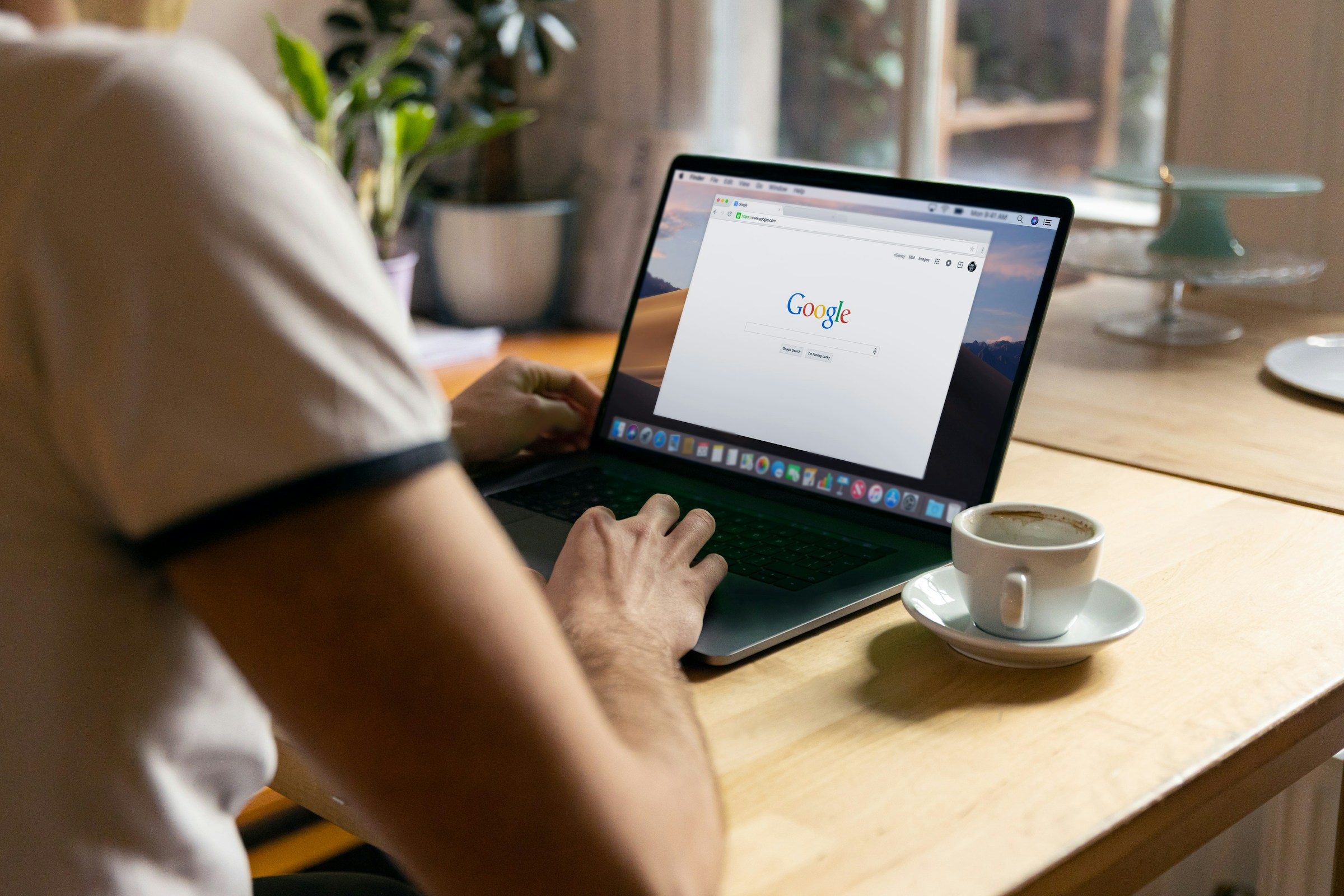 man searching on google - Monitor Search Engine Rankings